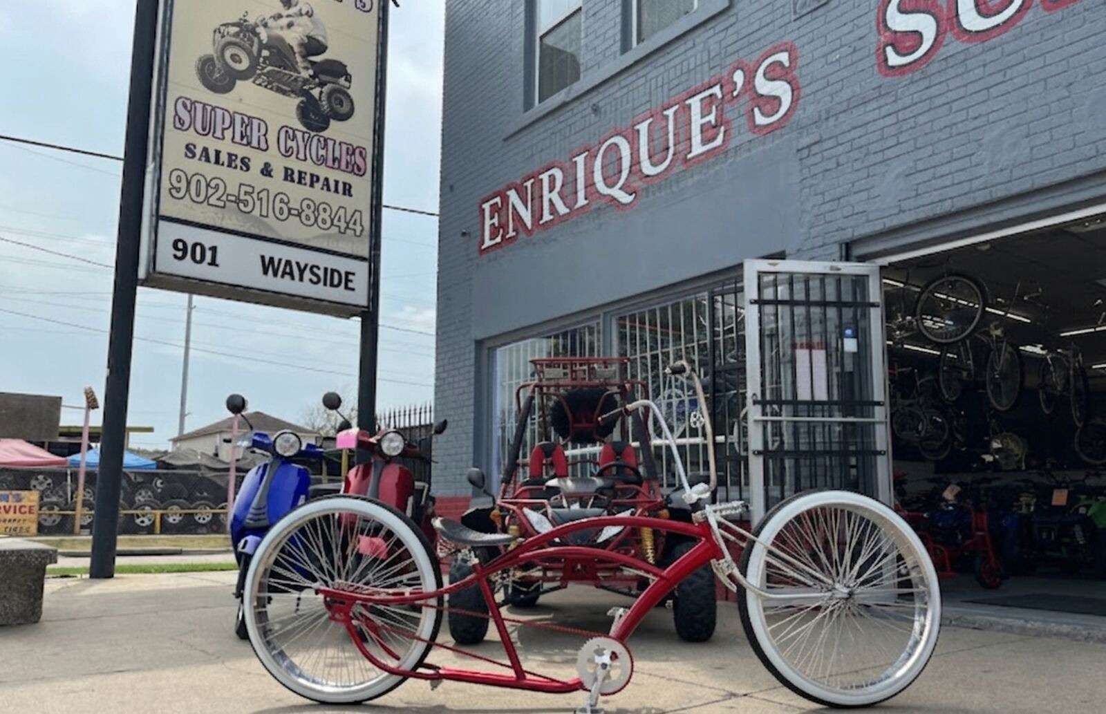 Enrique's Super Cycles storefront at 901 Wayside with custom lowrider bike and ATV